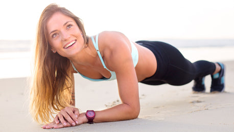 Woman Performing a Workout Plank on a Beach